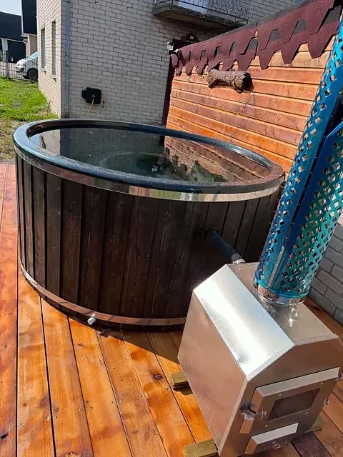Dark tub with stainless external stove on a terrace
